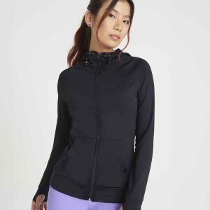 Woman presenting the JC058 AWDis Ladies Cool Contrast Zoodie, a stylish choice for gym clothing and casual workwear.