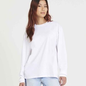 Woman wearing JT019 AWDis Unisex Oversize 100 Long Sleeve T-Shirt, perfect for a relaxed yet professional style.