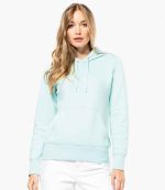 Woman wearing the KB4028 Kariban Ladies Eco-Friendly Hooded Sweatshirt in soft pastel, blending eco-conscious living with fashion.