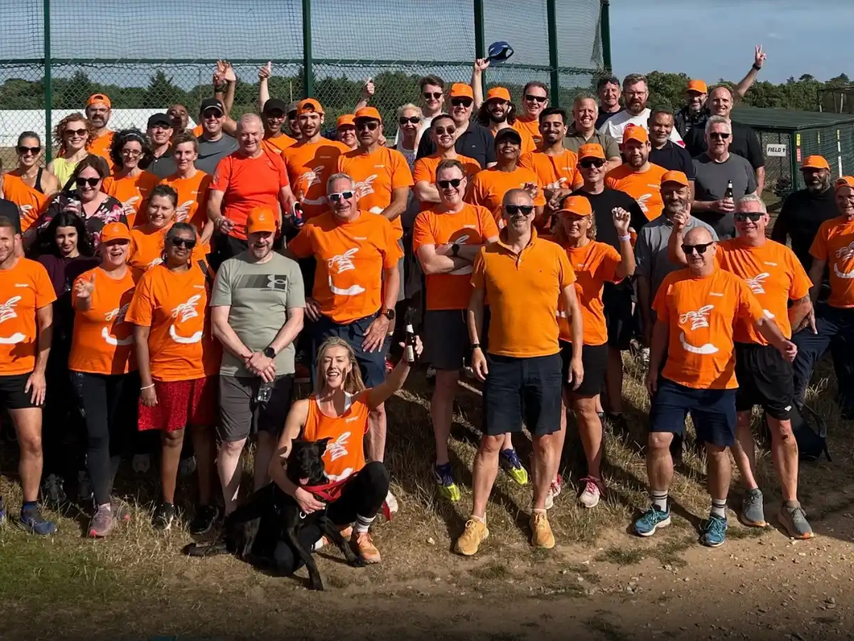A large team in matching branded t-shirts and caps