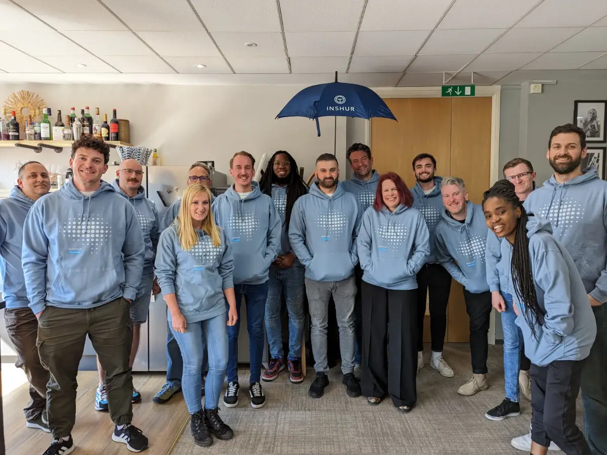 An office team in matching branded hoodies