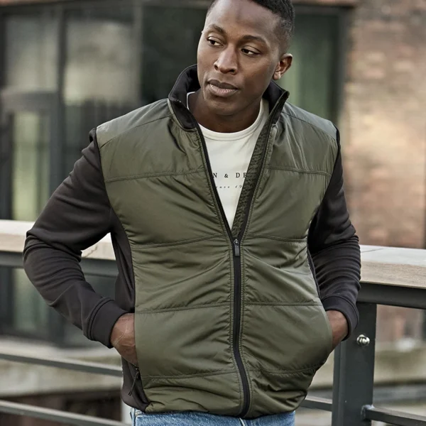 Tee Jays Hybrid-Stretch Jacket in Deep Green/Black, worn