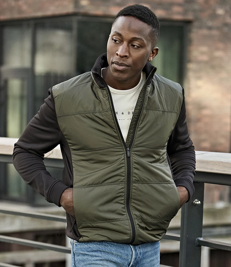 Tee Jays Hybrid-Stretch Jacket in Deep Green/Black, worn