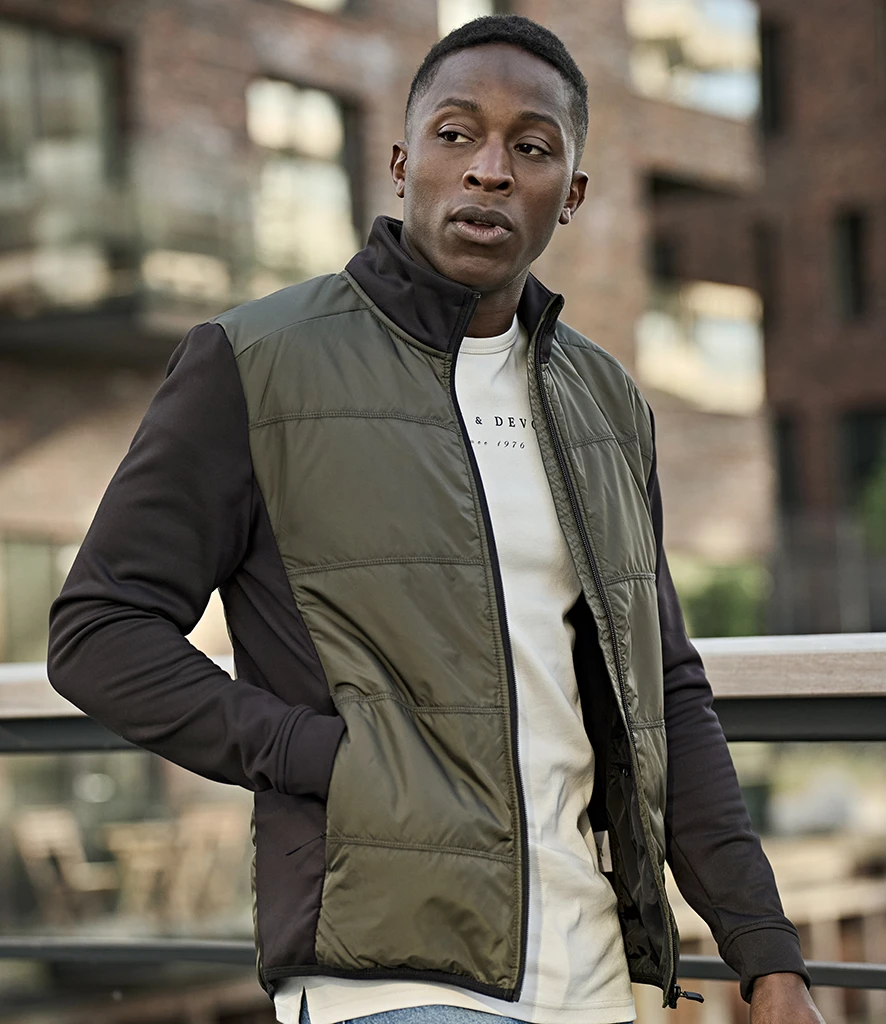 Tee Jays Hybrid-Stretch Jacket in Deep Green/Black, worn