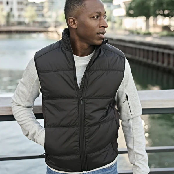 Tee Jays Hybrid-Stretch Bodywarmer in Deep Green/Black, worn