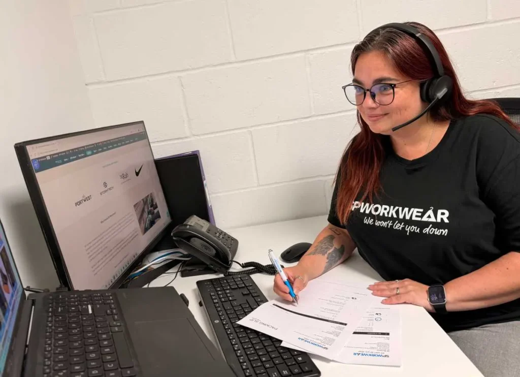 Chloe at her desk taking a repeat order