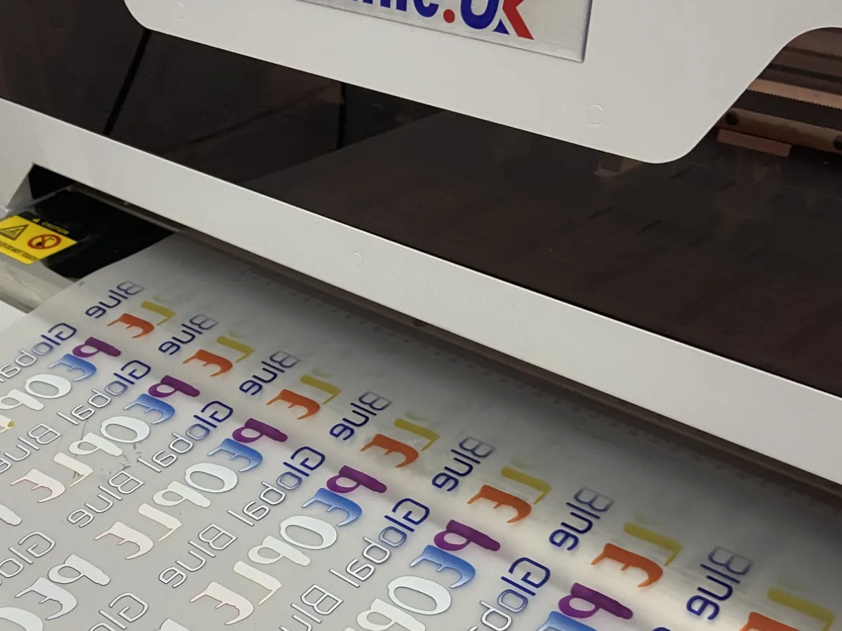DTF transfer film with full-colour logos coming off our printer