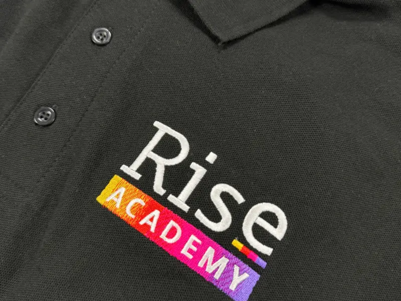 Embroidered polo logo where a colour gradient has been stitched as solid colour steps